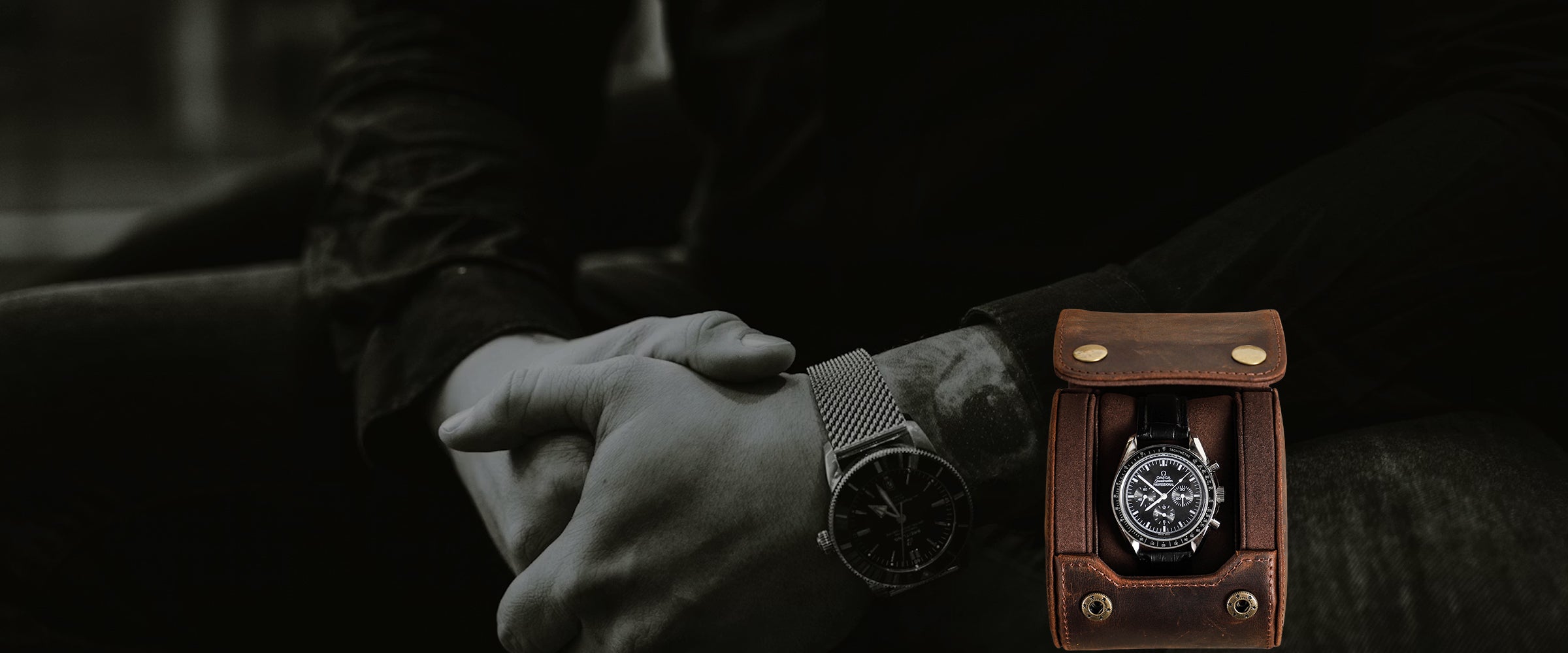 Person wearing a watch with another watch in a leather watch case on a dark background