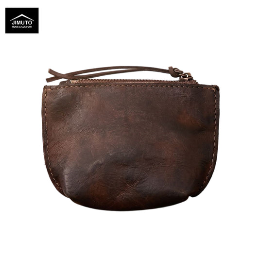 A dark brown distressed leather coin pouch with a top zipper and wrist strap, shown on a plain white background with a Jimuto brand logo in the top-left corner.