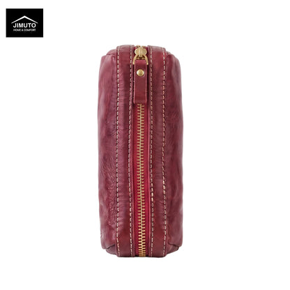 A vertical rectangular leather pen pouch in a deep burgundy red, featuring a central gold-tone zipper with white contrast stitching and a small gold rivet. The Jimuto brand logo is visible in the top-left corner on a plain white background.