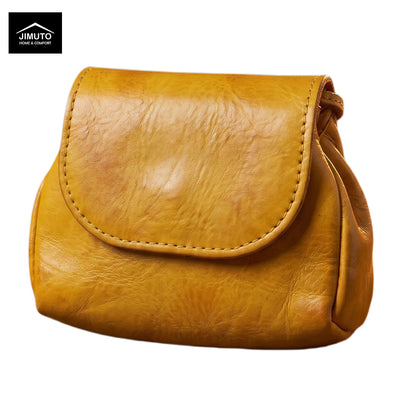 A mustard yellow leather clutch with a textured finish and a stitched flap closure, shown against a plain white background with a JIMUTO brand logo in the top-left corner.